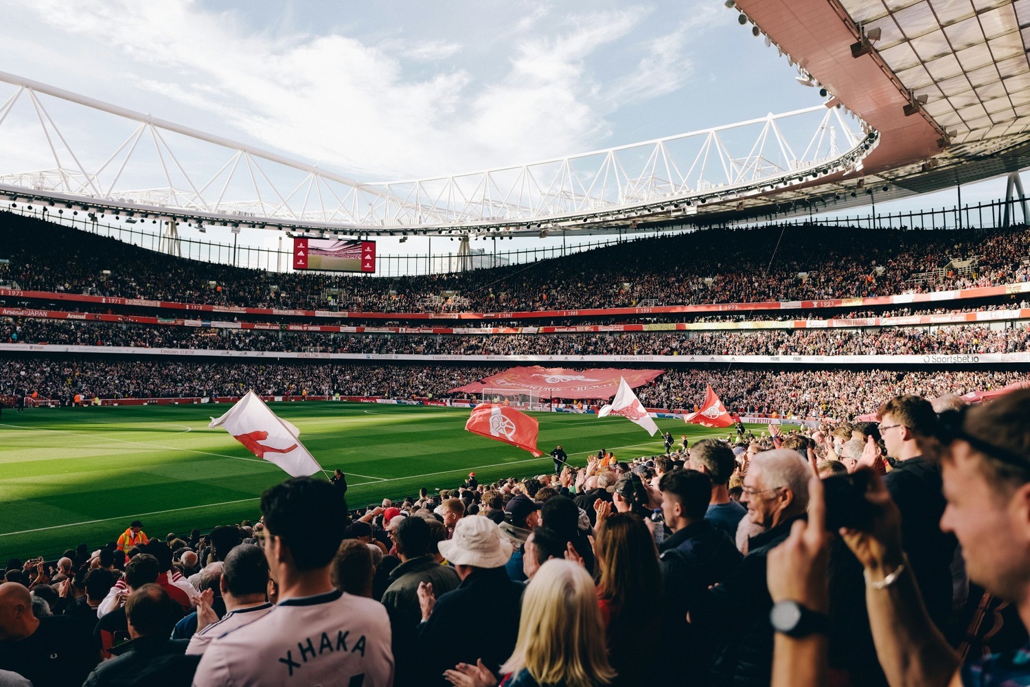 A crowd celebrating in the stand on a matchday