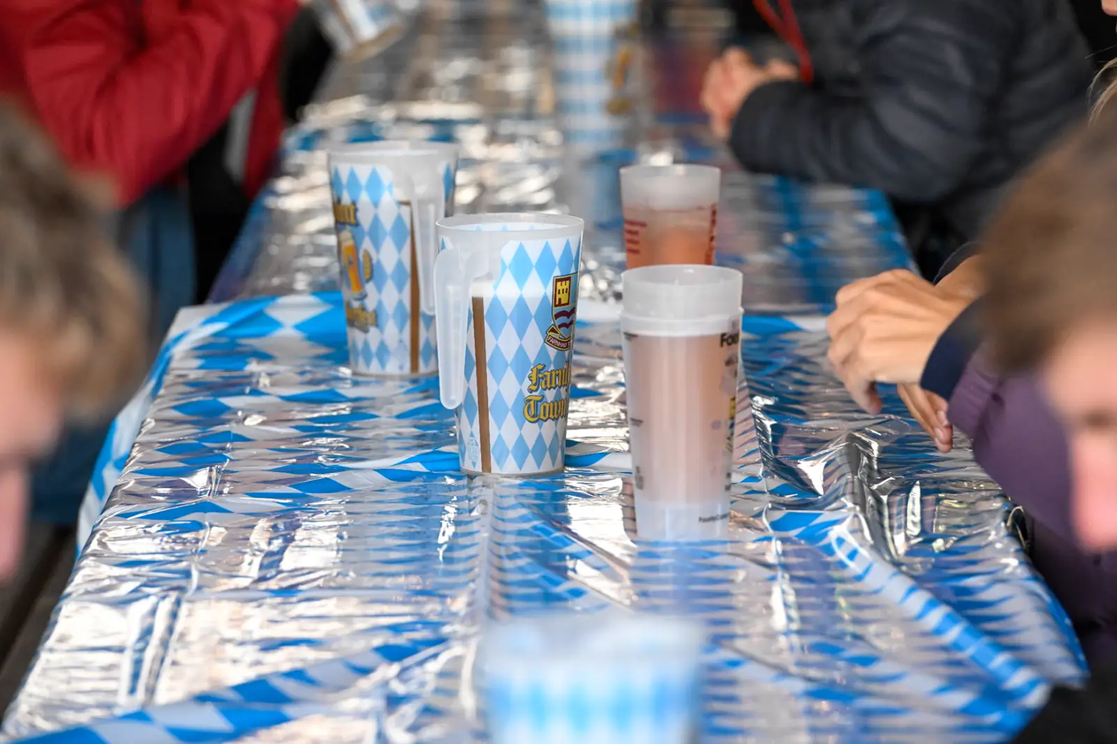Two-pint Farnham Town Oktoberfest steins on a long blue and white table