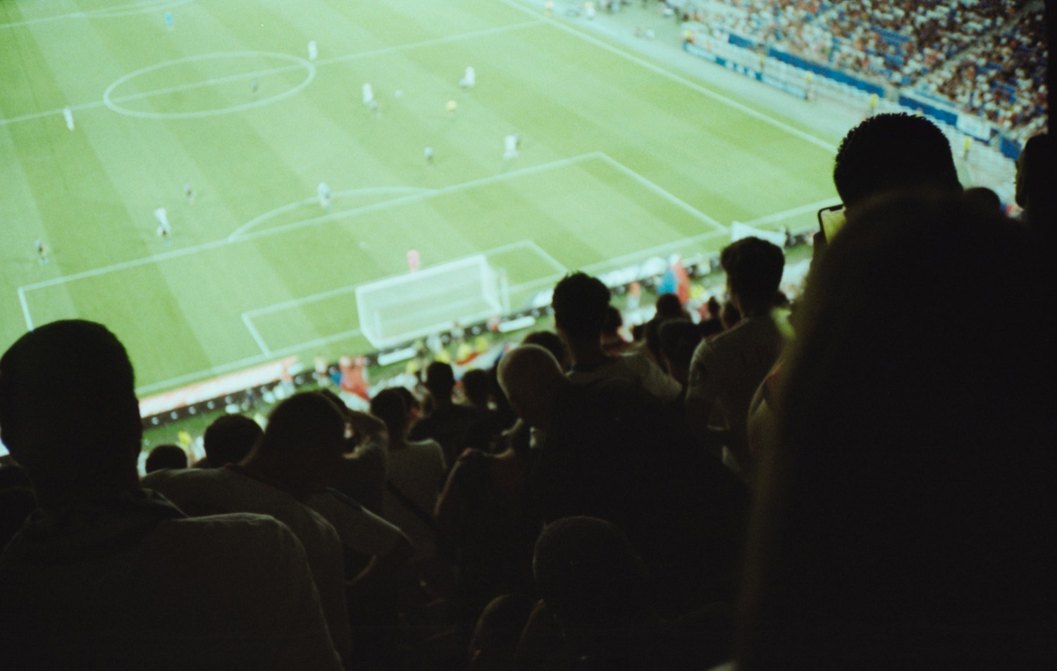 Supporters in the stand looking out over a full pitch