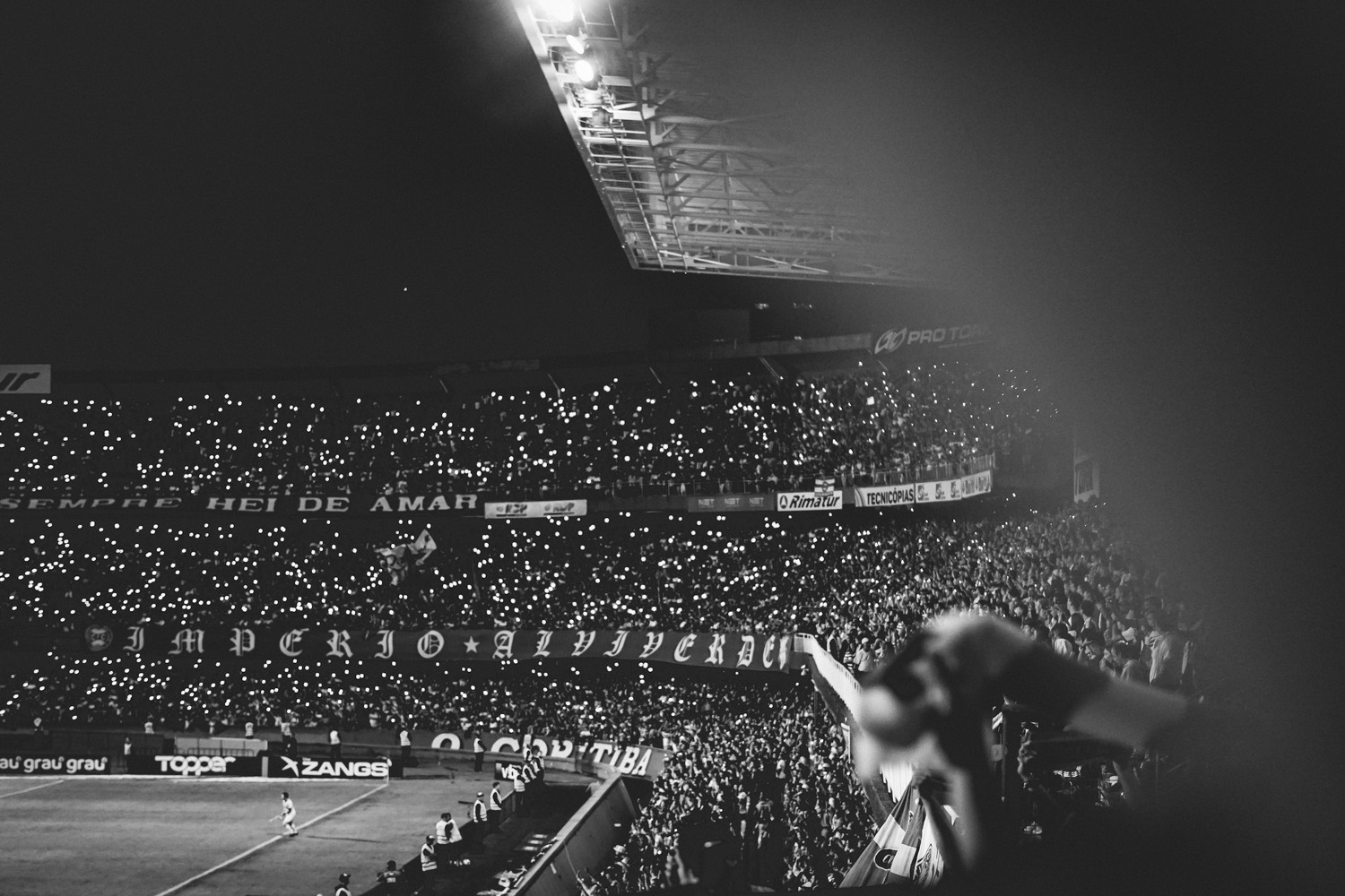 A packed terrace at night through a season