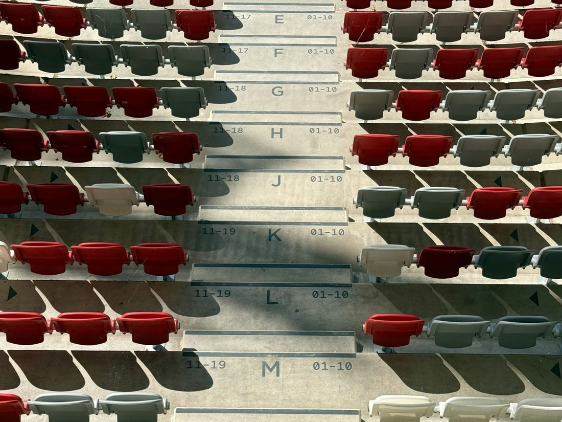 Empty rows of seats marked out by row letter