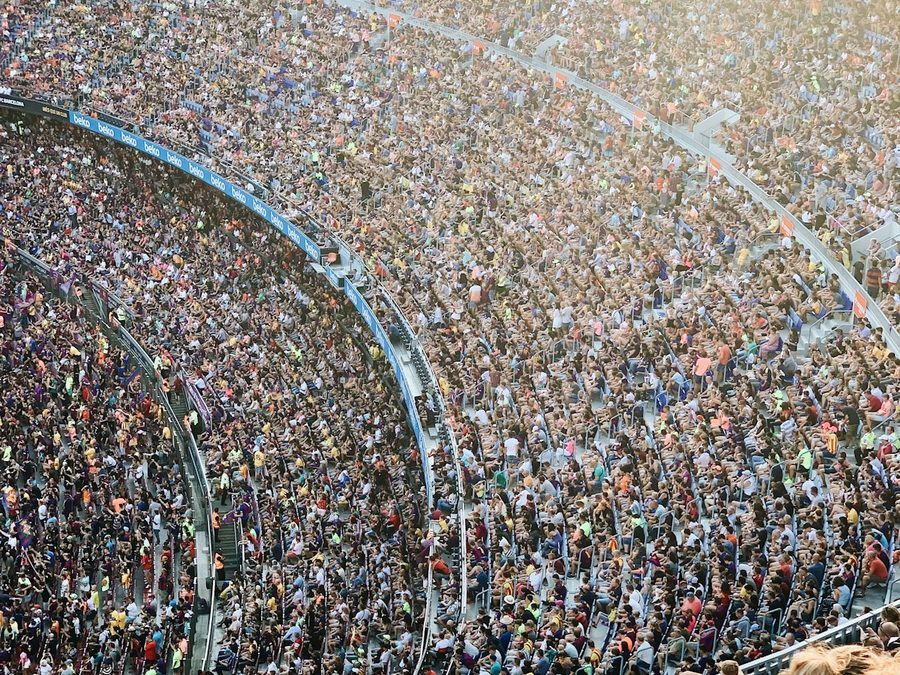 A full stand of supporters watching a match